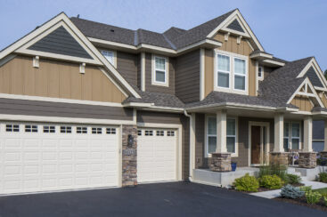 House with LP Siding and 3 car garage - multi-color house with dark grey driveway