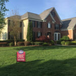 Exterrior home with new roofing, siding, and windows with O.C. Taylor sign