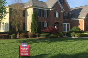 Exterrior home with new roofing, siding, and windows with O.C. Taylor sign