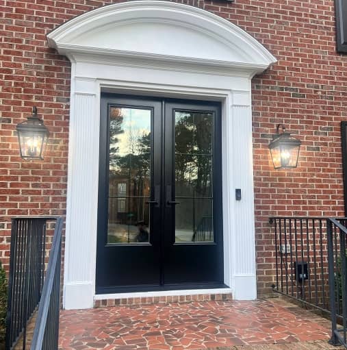 black-double-door-whit-trim-brick